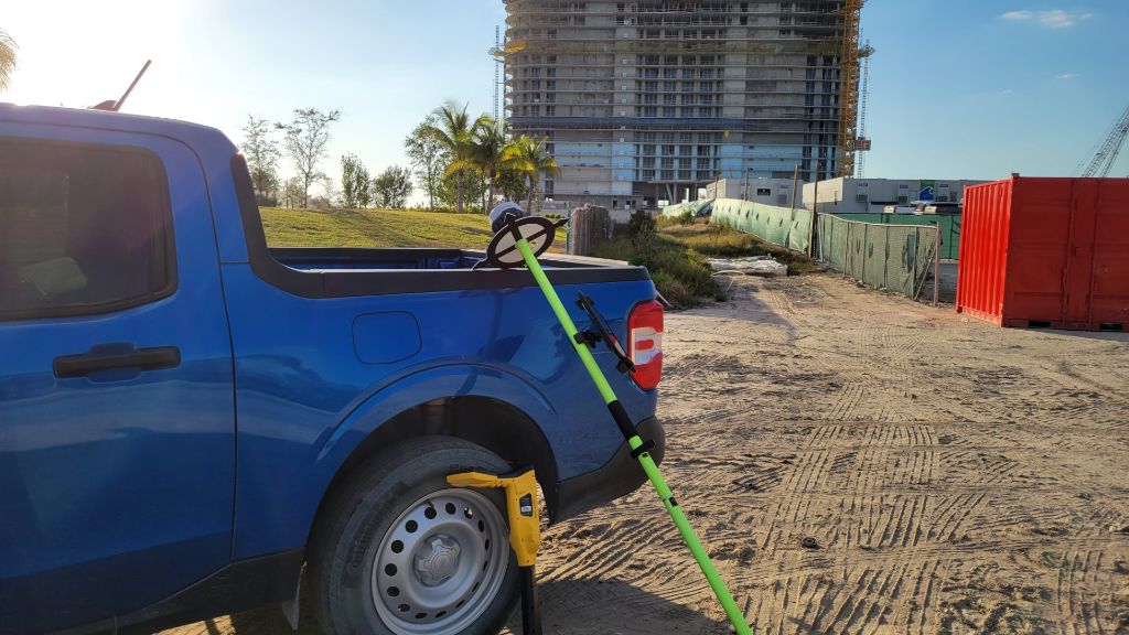 GNSS rover setup on construction site with building in background showing quick deployment